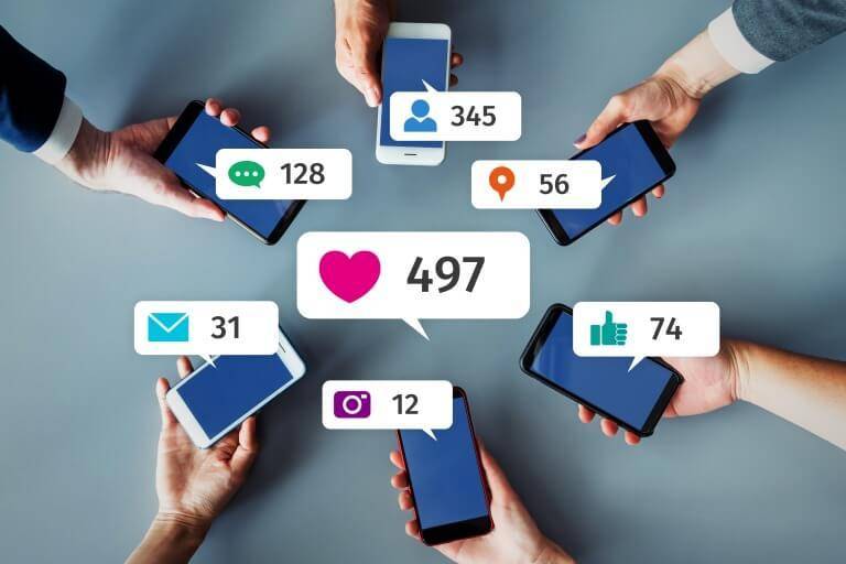Multiple hands holding smartphones display various social media notifications, with a central graphic showing 497 likes.